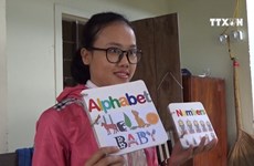 Rural woman makes colourful books from recycled paper