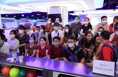 Young people excitedly cheer for bowling at SEA Games 31