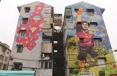 Colourful murals cover old buildings in HCM City