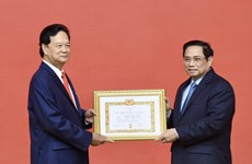Former Prime Minister presented with 55-year Party membership badge