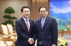 PM Pham Minh Chinh receives Lao Deputy PM, Foreign Minister