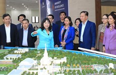 Lao Party officials visit Hanoi craft village, university