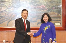 Vietnam, Laos step up experience exchange on mass mobilisation  