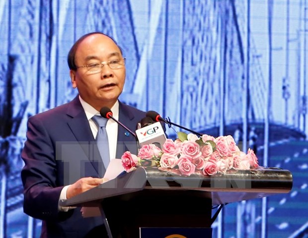 PM urges Hanoi to remove barriers for stronger development hinh anh 1