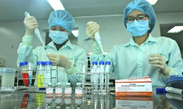 Vaccine self-sufficiency needed to return to new normal: Deputy PM hinh anh 1