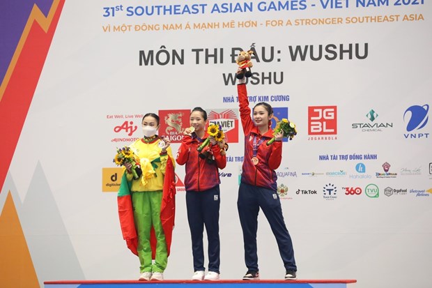 SEA Games 31: Vietnam win golds in running, rowing, wushu hinh anh 2
